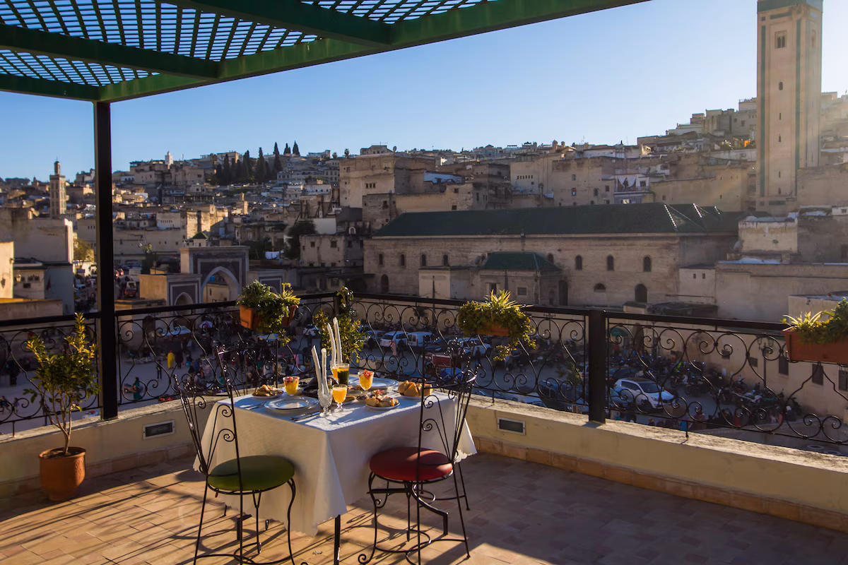 Terrasse panoramique du Riad Fès Bab Rcif au coucher du soleil, avec vue sur les toits de la médina de Fès